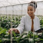 this is an image of a lady in green house practising agribusiness