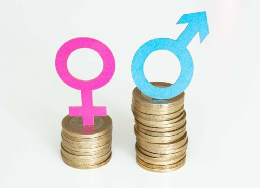 Female and male gender symbol on coins. Gender wage gap.